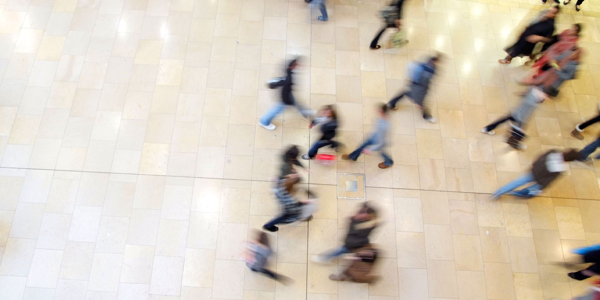 A crowd of people in a shopping centre, shown from above.